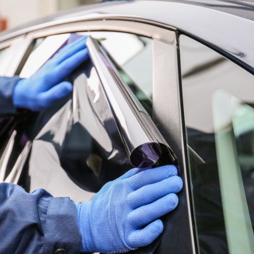 Sedan receiving ceramic window tinting in Chicago shop